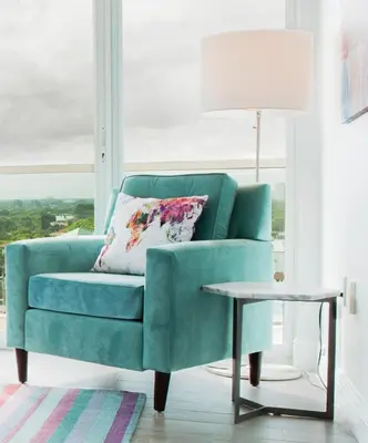 a green couch in a living room with a table at Private 2 bedroom bay view condo in Coconut Grove includes parking in Miami