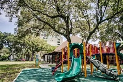 a playground with a slide in a park at Private 2 bedroom bay view condo in Coconut Grove includes parking in Miami