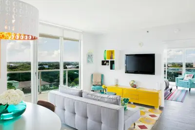 a living room with a couch and a tv at Private 2 bedroom bay view condo in Coconut Grove includes parking in Miami