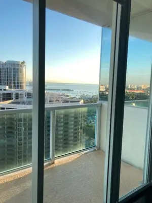 a view of the ocean from a balcony of a building at Luxury Penthouse with Private Rooftop Terrace in Coconut Grove Hotel in Miami
