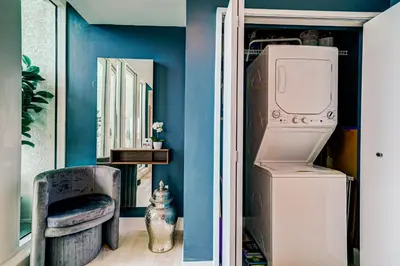a room with a washer and dryer and a blue wall at Luxury 2-story Penthouse located in Coconut Grove Hotel-includes Parking in Miami