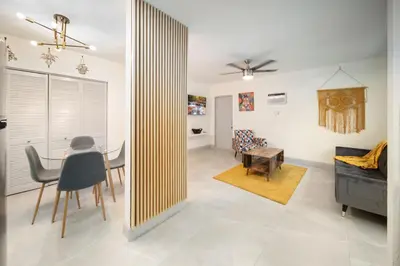 a living room with a table and a couch at Modern Apt Near Las Olas Beach in Fort Lauderdale