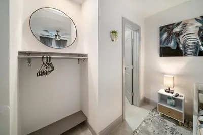 a bathroom with a mirror and a hallway at Modern Apt Near Las Olas Beach in Fort Lauderdale