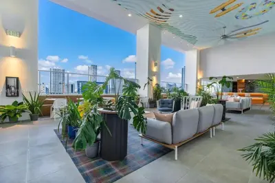 a lobby with a couch and potted plants at Modern Studio Downtown with Pool and Gym in Miami