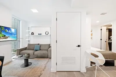 a living room with a couch and a table at Ocean View Cozy Studio Pool and Gym in Miami