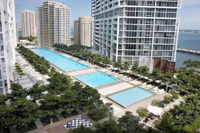 an aerial view of two pools in a city with tall buildings at Deluxe Suite King 1 Bedroom Icon in Miami