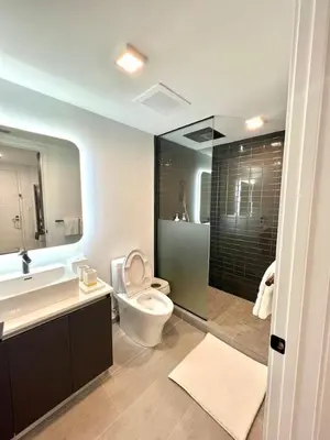 a bathroom with a toilet and a sink and a shower at Ocean view Studio Pool and gym in Miami