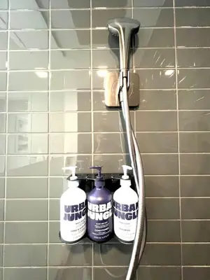 three bottles of cleaning products on a shelf in a bathroom at Ocean view Studio Pool and gym in Miami