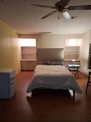 a bedroom with a large bed and a table at 1233 Apartment 4 Miami in Tamiami