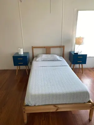 a bed in a room with two blue tables at 1233 Apartment 4 Miami in Tamiami