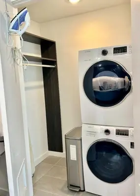 a washer and dryer sitting in a room at Upscale Ocean View Studio Pool and Gym in Miami