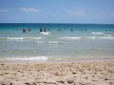 a group of people in the water at the beach at Tropical Classic Retro Florida, Private 2 bedroom Suite with Best Location in Fort Lauderdale