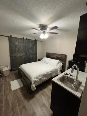 a bedroom with a bed and a ceiling fan at cozy studio apartment with private entrance and patio in Miami