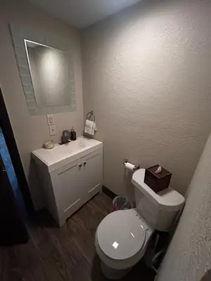 a bathroom with a white toilet and a sink at cozy studio apartment with private entrance and patio in Miami