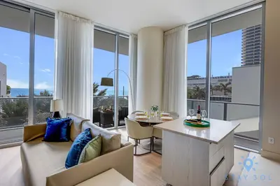 a living room with a couch and a table at Spectacular ocean and beach view in Hollywood