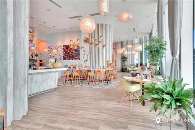 a restaurant with a bar and tables and chairs at Spectacular ocean and beach view in Hollywood