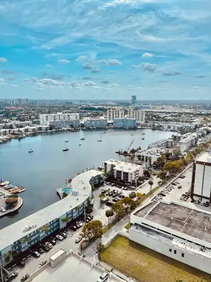 an aerial view of a city with a body of water at Beachwalk Studio (Beach, Pool and Gym) in Hallandale Beach