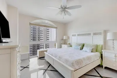 a bedroom with a bed and a ceiling fan at 2 BR Monthly beach condo Miami in Hallandale Beach