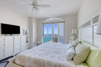 a bedroom with a bed and a tv and a window at 2 BR Monthly beach condo Miami in Hallandale Beach