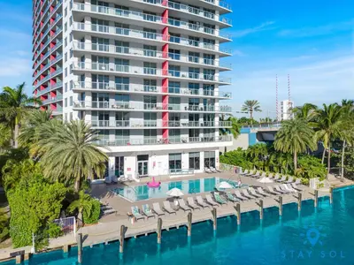 an aerial view of a resort with a pool and chairs at Beachwalk Studio Amazing View Pininfarina Design in Hallandale Beach