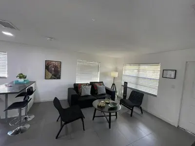 a living room with a couch and chairs and a table at Stylish Pool Home in Hollywood