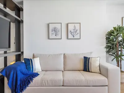 a white couch with blue pillows in a living room at Downtown by Miami Vacation Rentals in Miami
