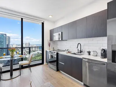a kitchen with stainless steel appliances and a large window at Downtown by Miami Vacation Rentals in Miami