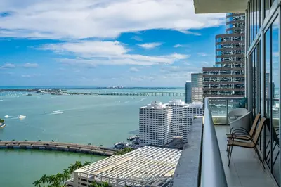 a balcony of a building with a view of the water at Icon 1 Bed With Water Views 16 ft Ceilings and Free Spa Access in Miami