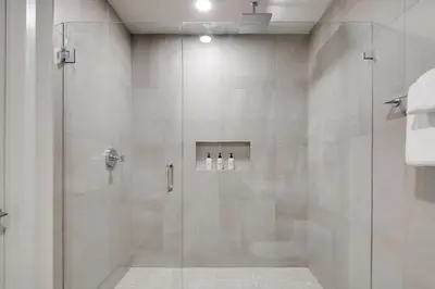 a bathroom with a shower with a glass door at Kasa Wynwood Miami in Miami