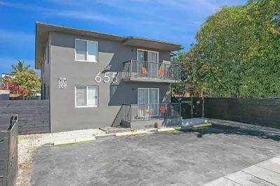 a house with a balcony on top of it at Elegant Wynwood Flats in Miami
