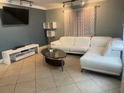 a living room with a couch and a table at Fort Lauderdale Party house! in Fort Lauderdale