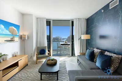 a living room with a couch and a table at Spectacular Infinite View Balcony Pool Gym in Hallandale Beach