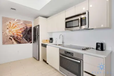 a kitchen with a sink and a microwave at Spectacular Infinite View Balcony Pool Gym in Hallandale Beach