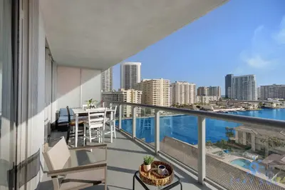 a balcony with a view of the city at South Beach Retreat Balcony Resort Amenities in Hallandale Beach