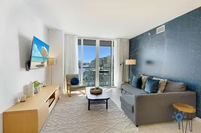 a living room with a couch and a table at South Beach Retreat Balcony Resort Amenities in Hallandale Beach