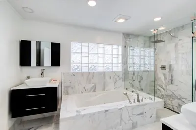 a bathroom with a tub and a sink at Marble House in Lauderdale Harbours in Fort Lauderdale