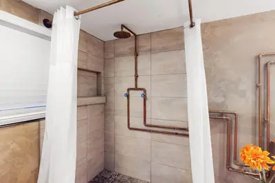 a shower in a bathroom with a shower curtain at Walking On Sunshine - Studio in Fort Lauderdale