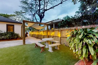 a backyard with a picnic table and a fence at Walking On Sunshine - Studio in Fort Lauderdale