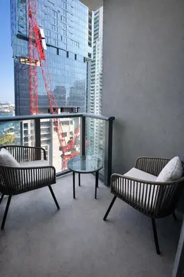 a room with two chairs and a glass table in front of a window at Downtown Miami 2Br 2Bath Oasis Bayside & Port of Miami Minutes Away in Miami