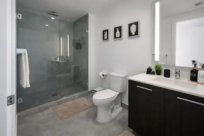 a bathroom with a shower and a toilet and a sink at Downtown Miami 2Br 2Bath Oasis Bayside & Port of Miami Minutes Away in Miami