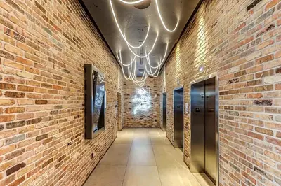 a hallway with a brick wall and a ceiling at Downtown Miami 2Br 2Bath Oasis Bayside & Port of Miami Minutes Away in Miami
