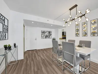 a dining room and living room with a table and chairs at Awesome Beach Condo with Resort Amenities 1016 in Miami Beach