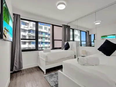 a bedroom with two beds and a large window at Gorgeous Miami Beach Condo 1614 in Miami Beach