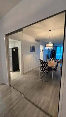 a room with a table and a dining room with a mirror at Apt w/2 Queen Beds & Ocean View at Tides in Hollywood