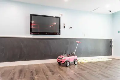 a small pink car parked in a room with a tv at Brickell High Rise Living at its best! w/ Pool Gym in Miami