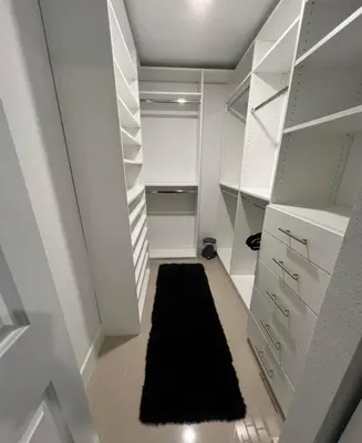a walk in closet with white cabinets and a black rug at NEW 3 Story in Homestead- 3/2.5 Balcony & Rooftop in Homestead