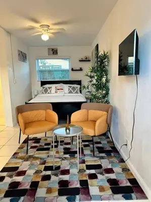 a living room with two chairs and a table at Cozy apartment near Seminole Hard Rock Cafe in Hollywood