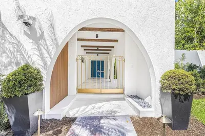 an entrance to a building with two potted plants at Villa Santa Maria in Cutler Bay