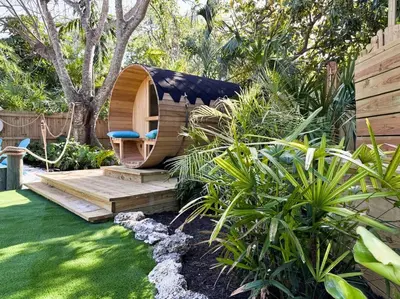 a sauna in a garden with a chair in it at Villa Santa Maria in Cutler Bay