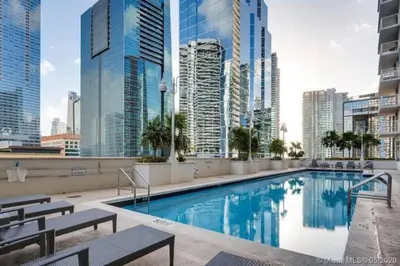 a pool on the roof of a building with tall buildings at Luxe 1 BDR • 32th Floor • Brickell • Ocean Views in Miami